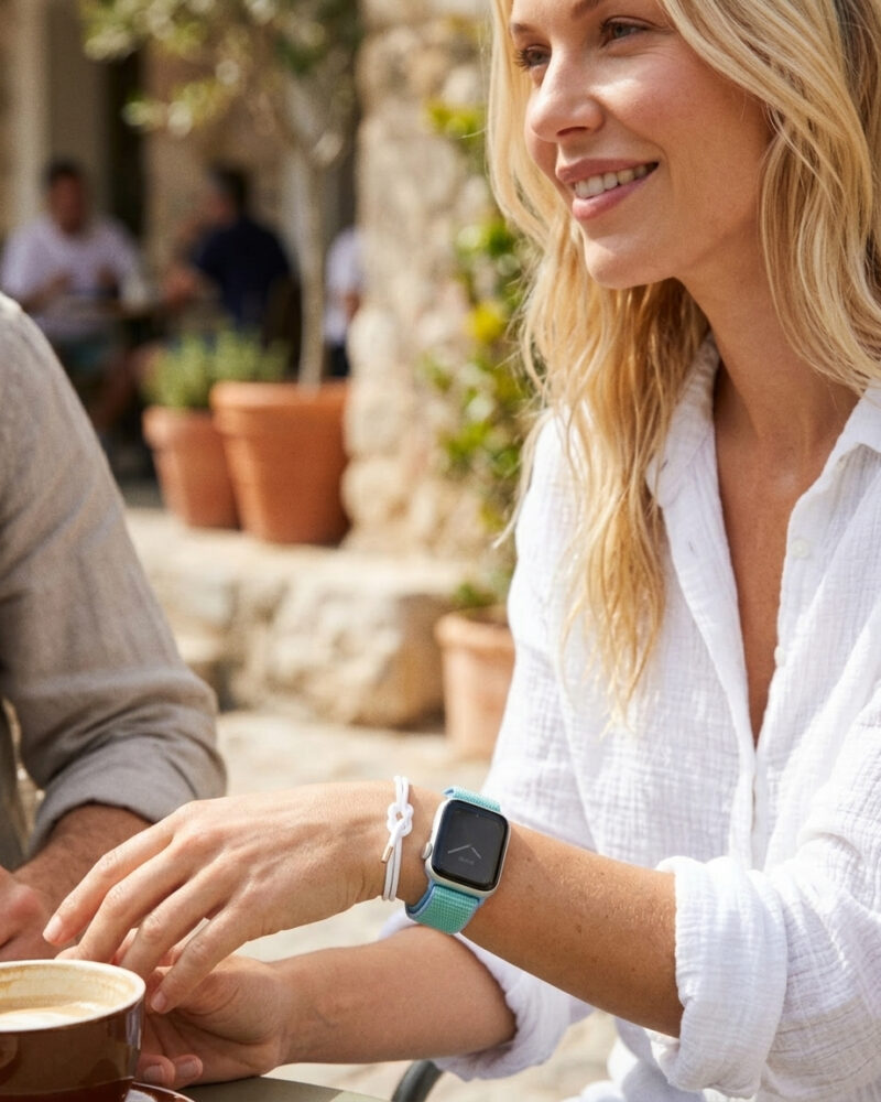 Woman wearing cornflower sport loop smartwatch at outdoor café gathering