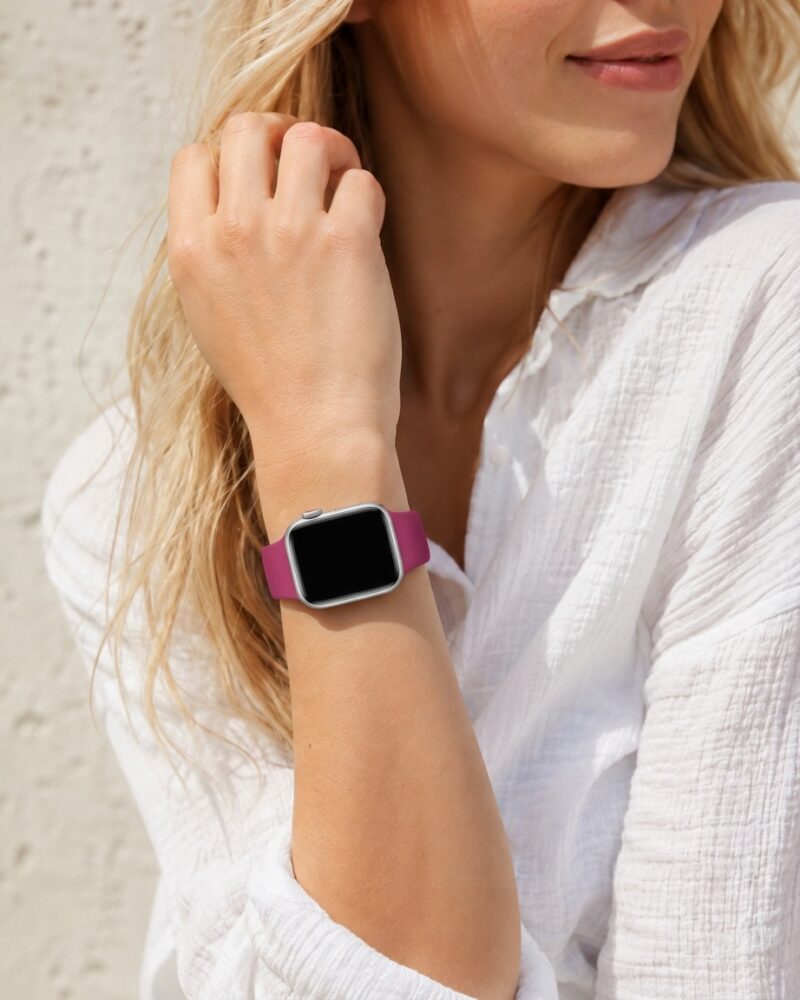 Woman wearing dragonfruit pink sport band smartwatch on wrist