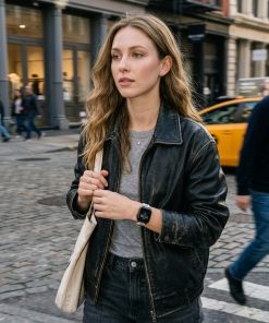 Woman wearing black leather jacket with cappuccino leather shoulder strap bag