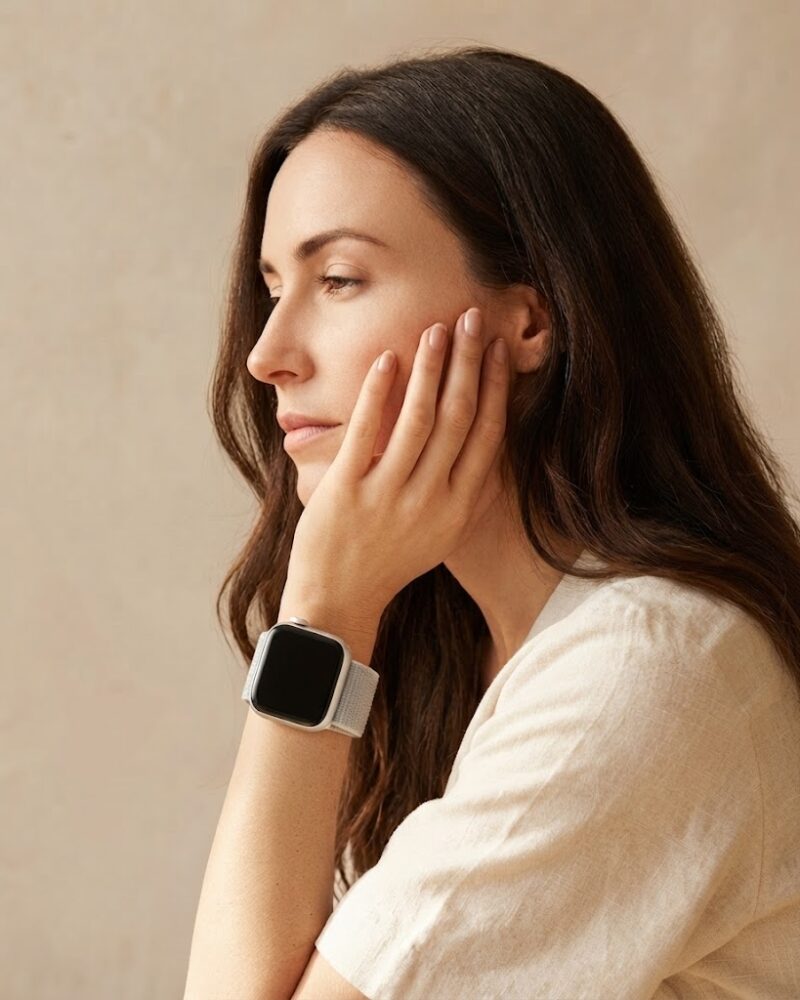 Woman wearing seashell sport loop smartwatch on wrist, side profile view