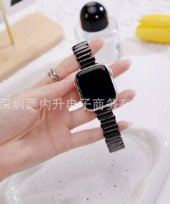 Black ceramic metal smartwatch band with silver case held in hand