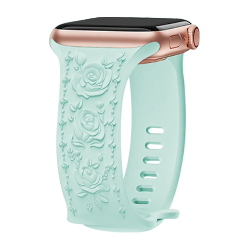 Mint green silicone smartwatch band with rose gold connector and floral design
