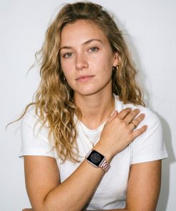Rose gold steel strap smartwatch band worn on woman's wrist