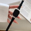 Woman wearing luxury smartwatch with black leather strap and diamond case