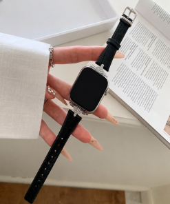 Woman wearing luxury smartwatch with black leather strap and diamond case