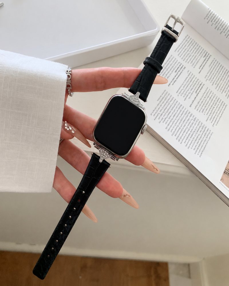Woman wearing luxury smartwatch with black leather strap and diamond case