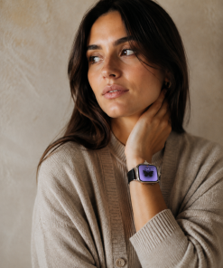 Woman wearing black leather crystal Apple Watch band with purple display
