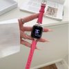 Crimson leather smartwatch band with diamond-studded metal connector on wrist
