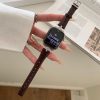 Dark brown leather Apple Watch band with rhinestone-studded case on wrist