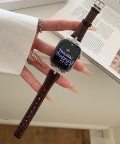 Dark brown leather Apple Watch band with rhinestone-studded case on wrist