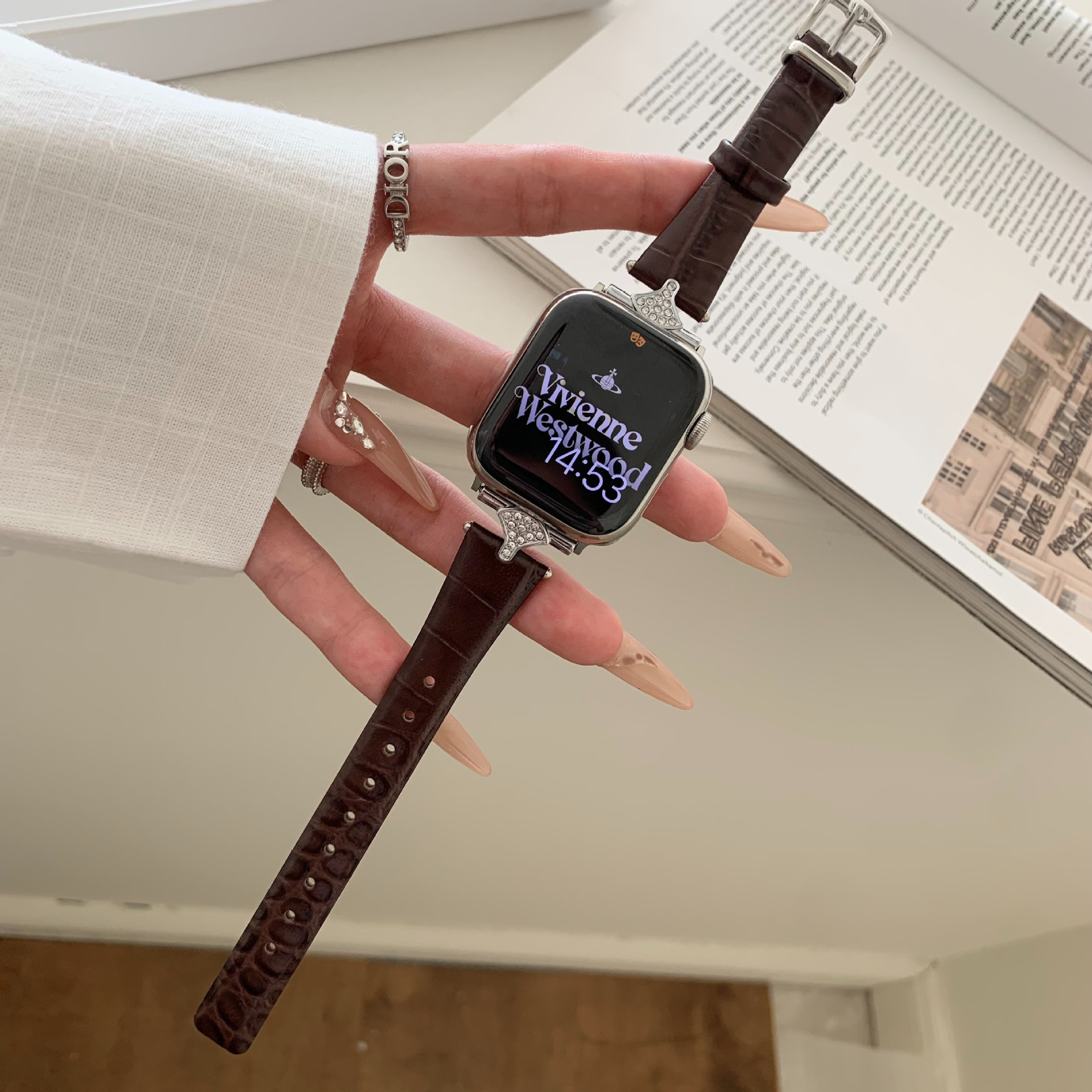 Dark brown leather Apple Watch band with rhinestone-studded case on wrist