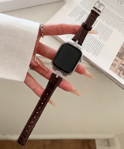 Apple Watch with dark brown leather strap and crystal bezel design