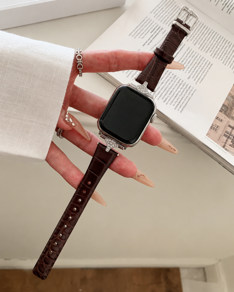 Apple Watch with dark brown leather strap and crystal bezel design