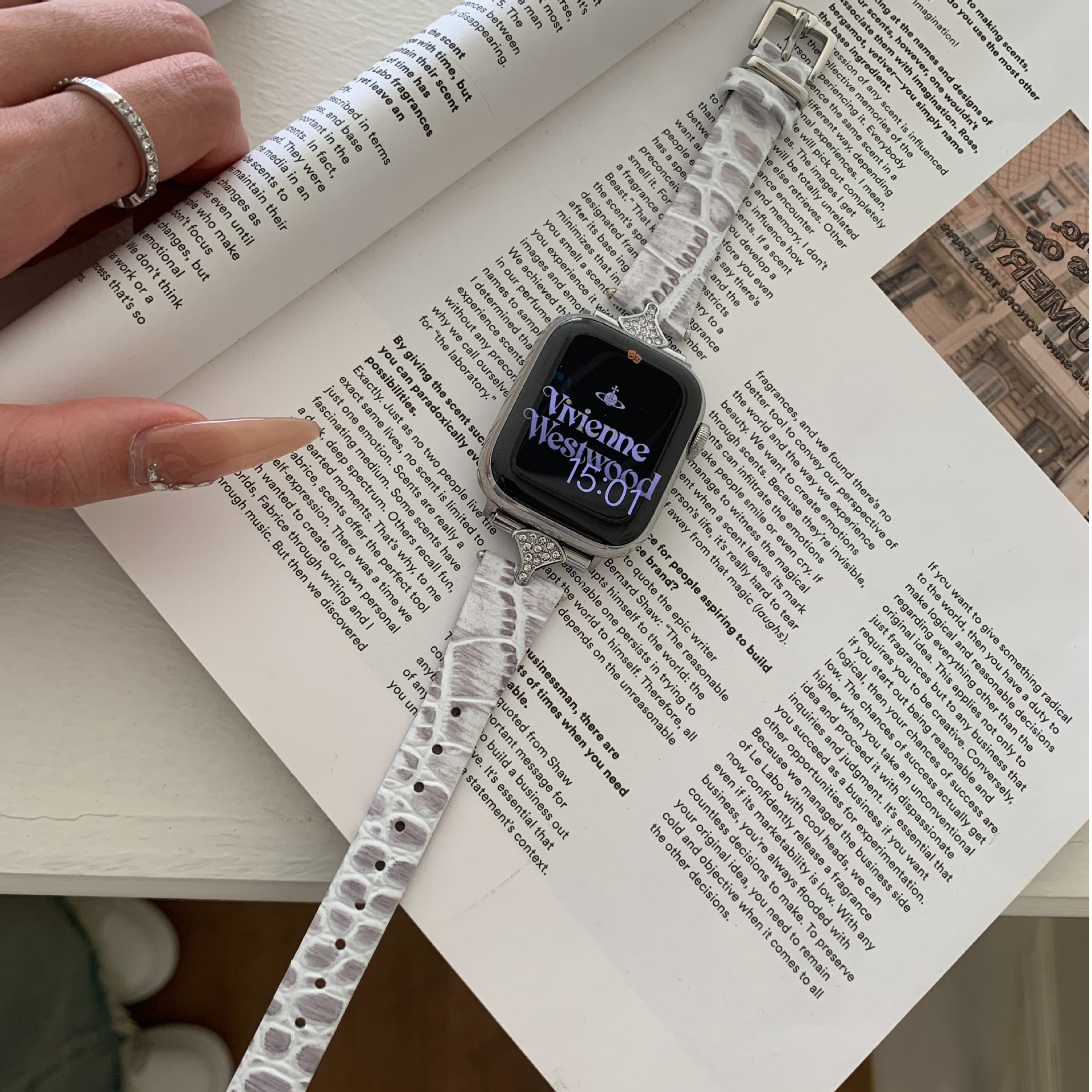 White leather Apple Watch band with crystal embellishments and metal case
