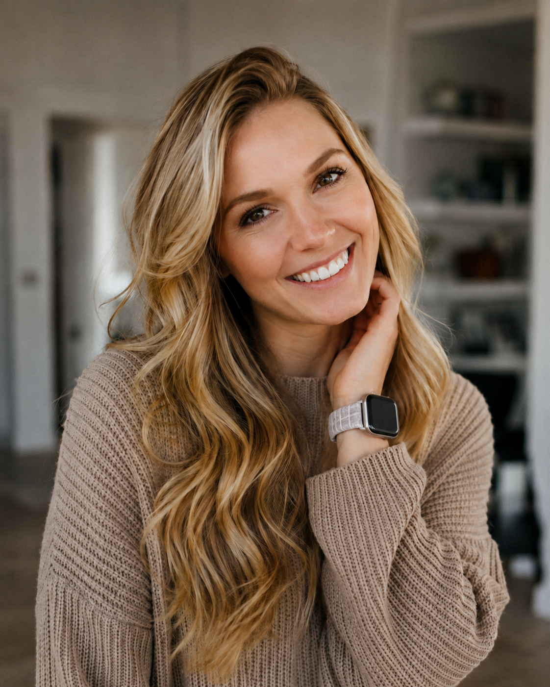 Woman wearing beige knit sweater with white leather Apple Watch band