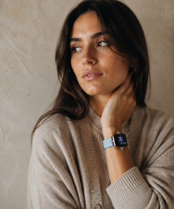 Lake blue leather Apple Watch band on woman's wrist, elegant accessory
