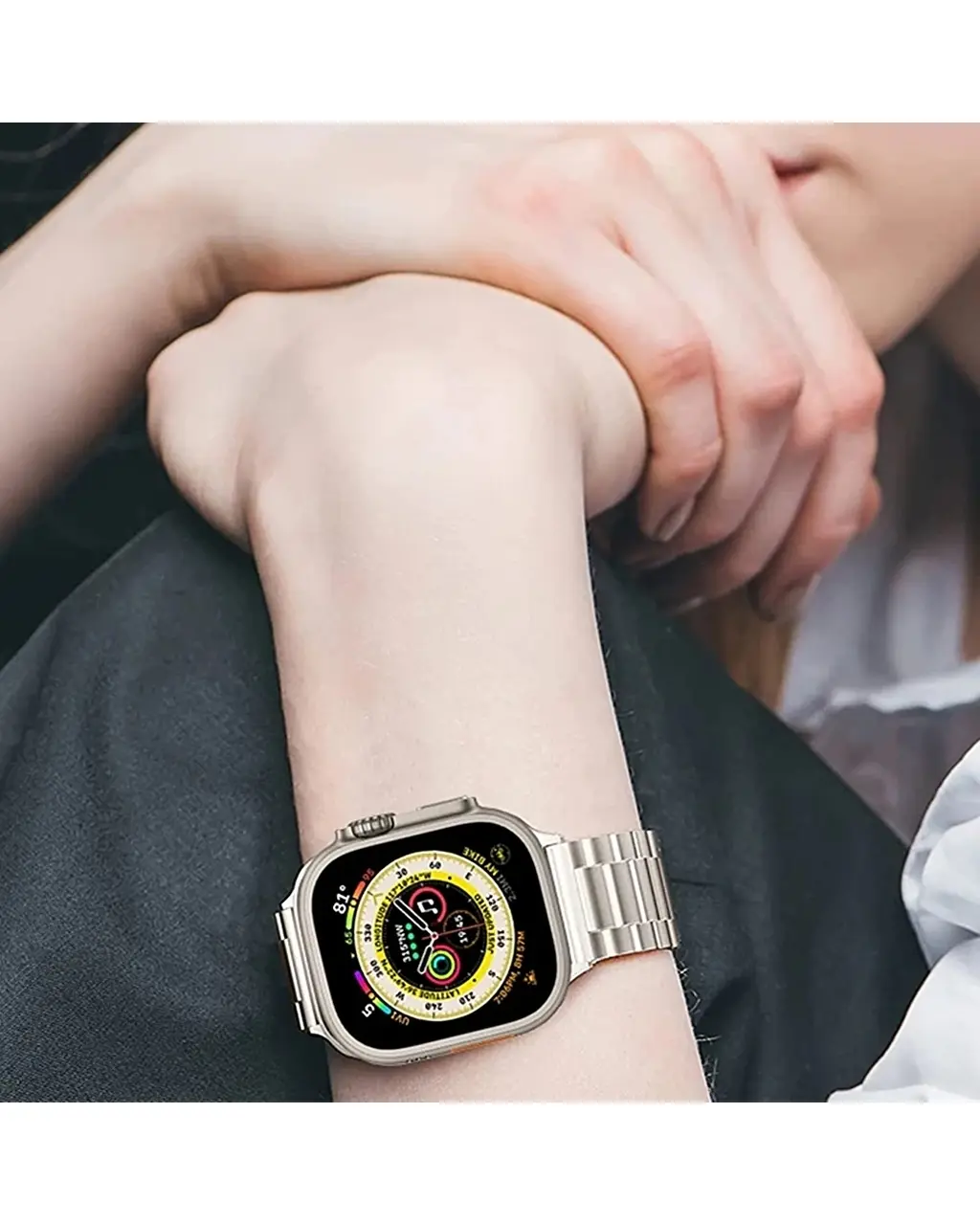 Stainless steel smartwatch with yellow dial face on wrist display