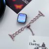 Rose gold heart-shaped smartwatch band with rhinestone accents and charm