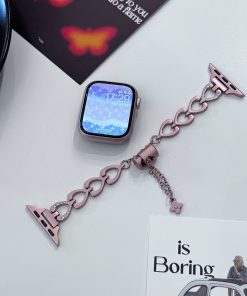 Rose gold heart-shaped smartwatch band with rhinestone accents and charm